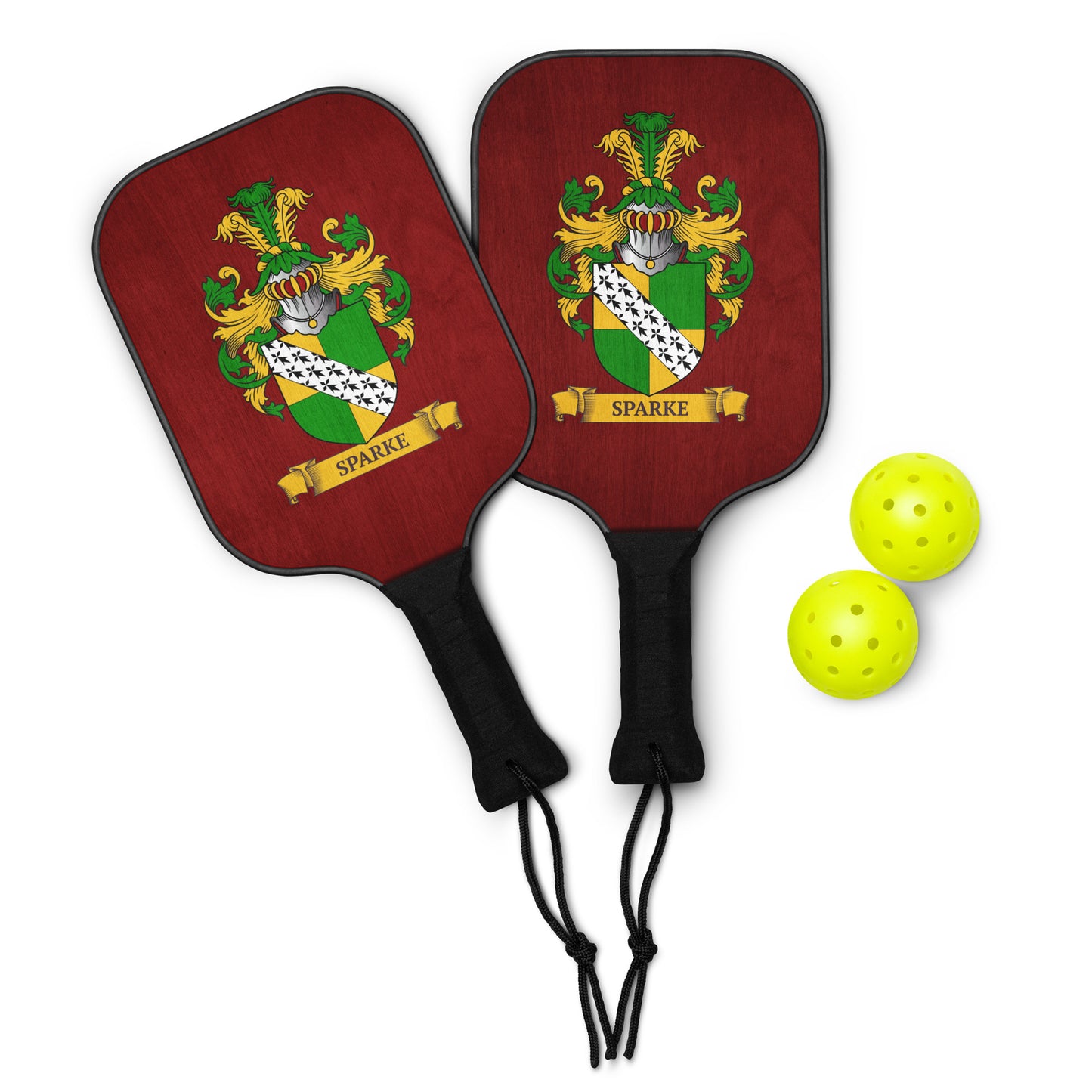 Two red family‑crest pickleball paddles shown together — each with a personalized crest and 2 green pickleballs nest to them.