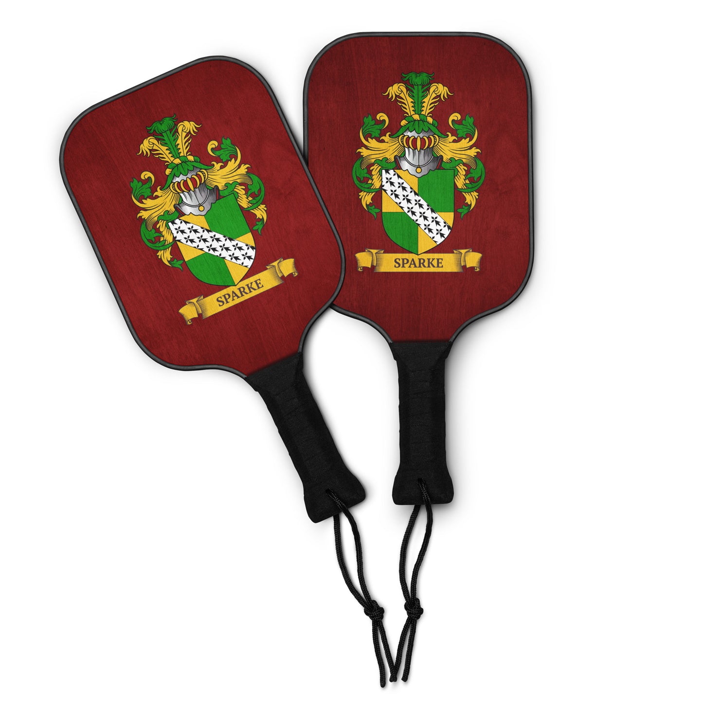 Two red pickleball paddles featuring a personalized family crest in them.