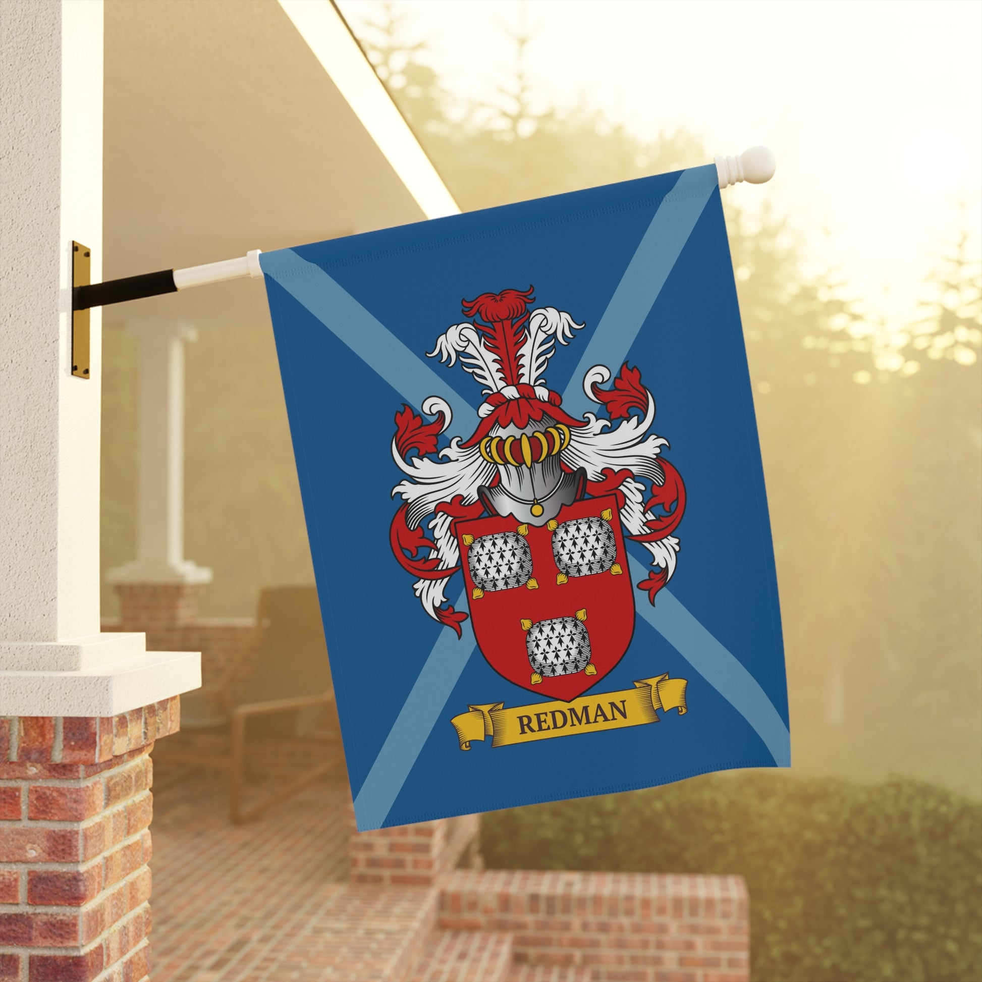 Garden Flag with a coat of arms and 'Redman' last name on a blue background, displayed outdoors.