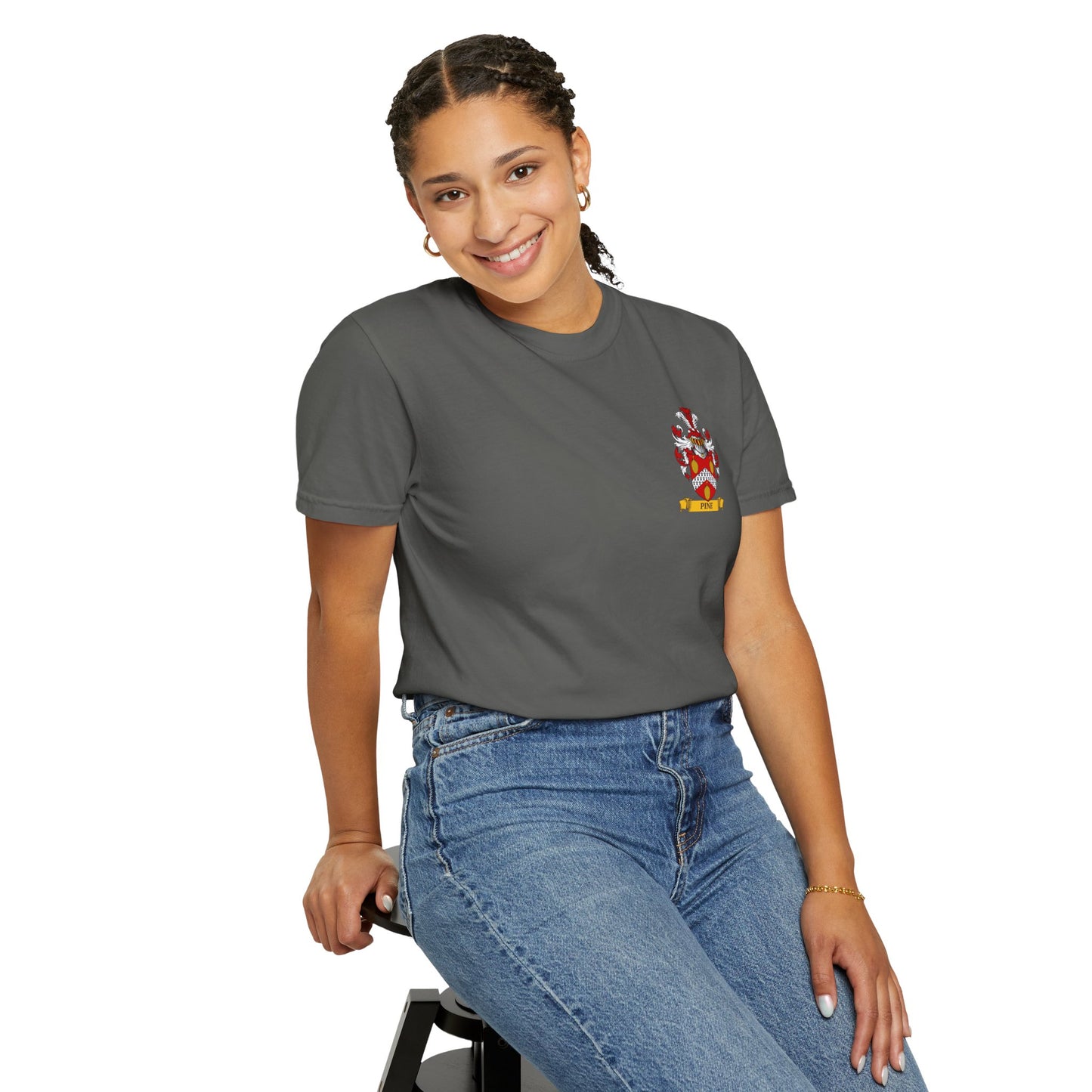 Smiling lady wearing a Garment-Dyed gray t-shirt with her personal family crest and blue jeans on a white background
