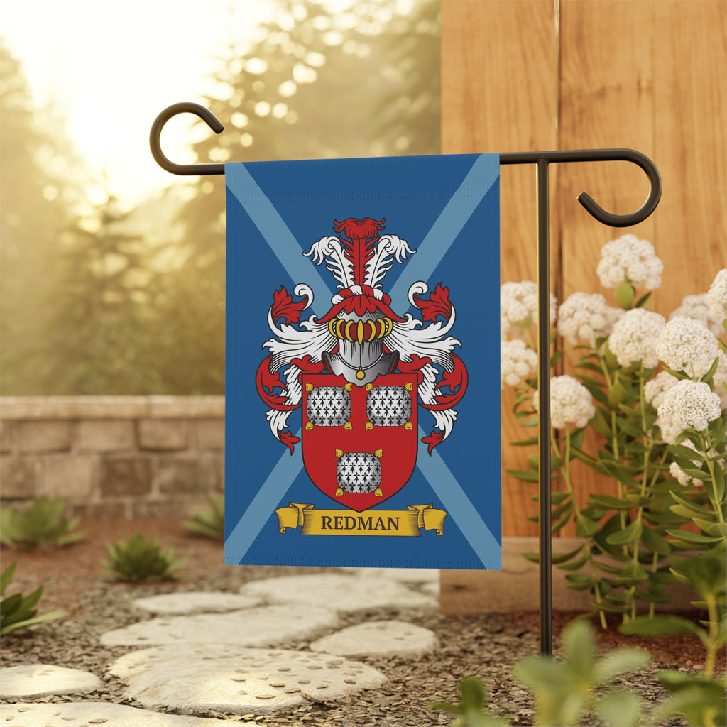 Personalized Garden flag with a red and blue coat of arms design on a stand outdoors.