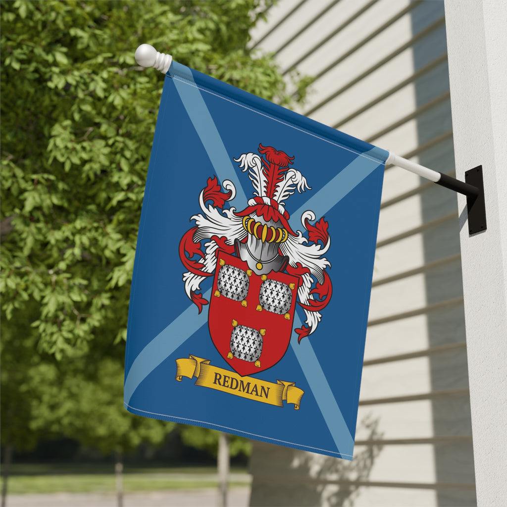Personalized blue family crest garden flag, attached to a building exterior.