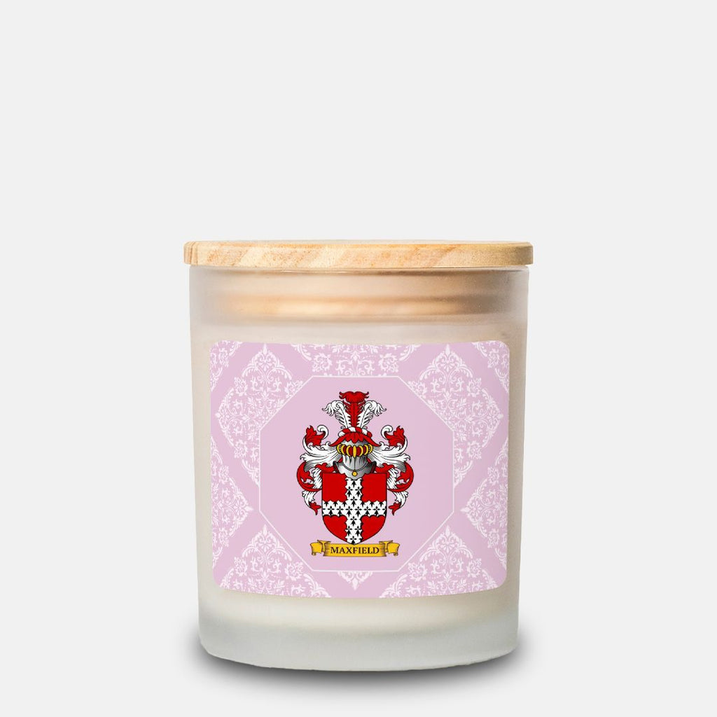 Customized scented candle with a decorative label featuring a customized family crest on a pink and white background