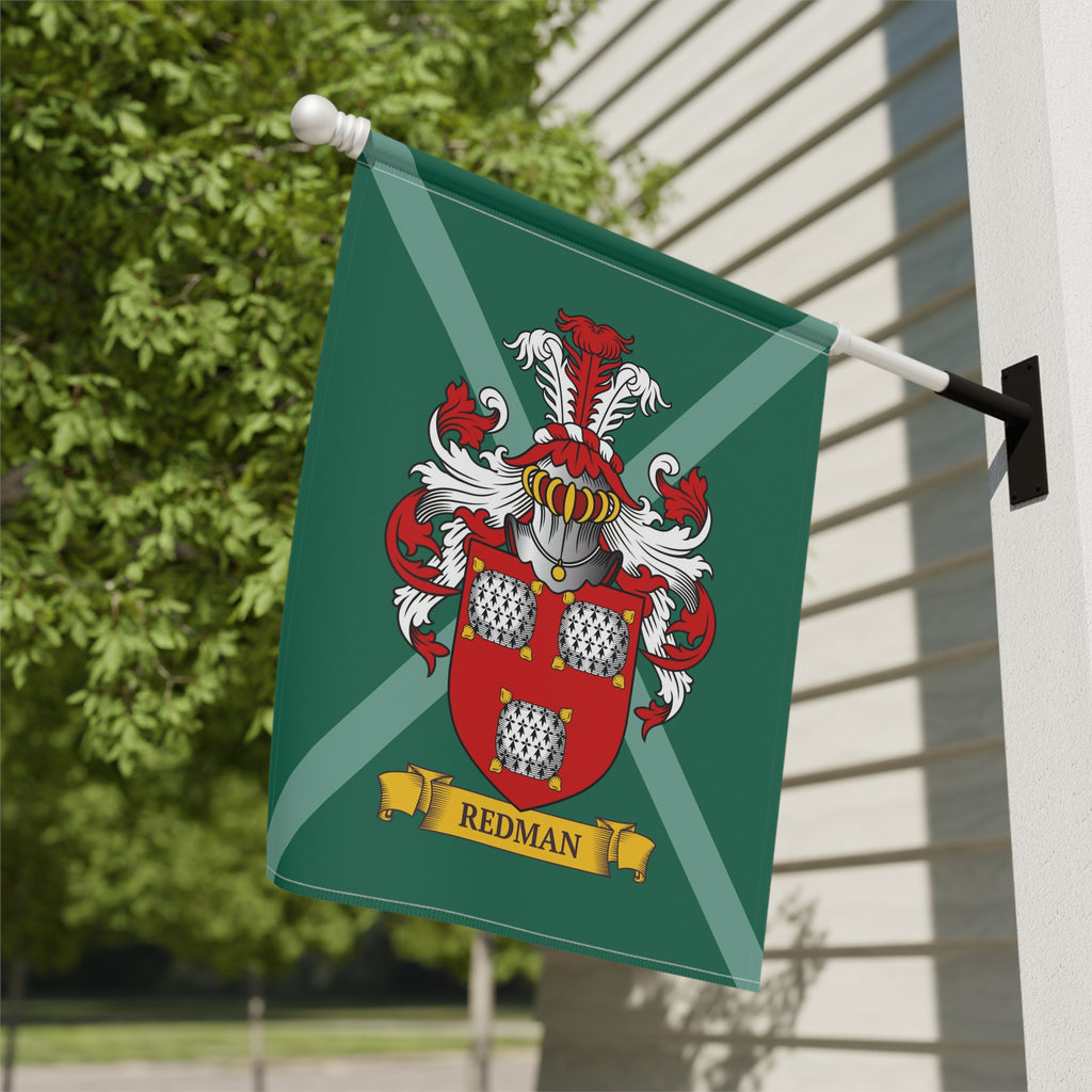 Personalized green family crest garden flag attached to a building.