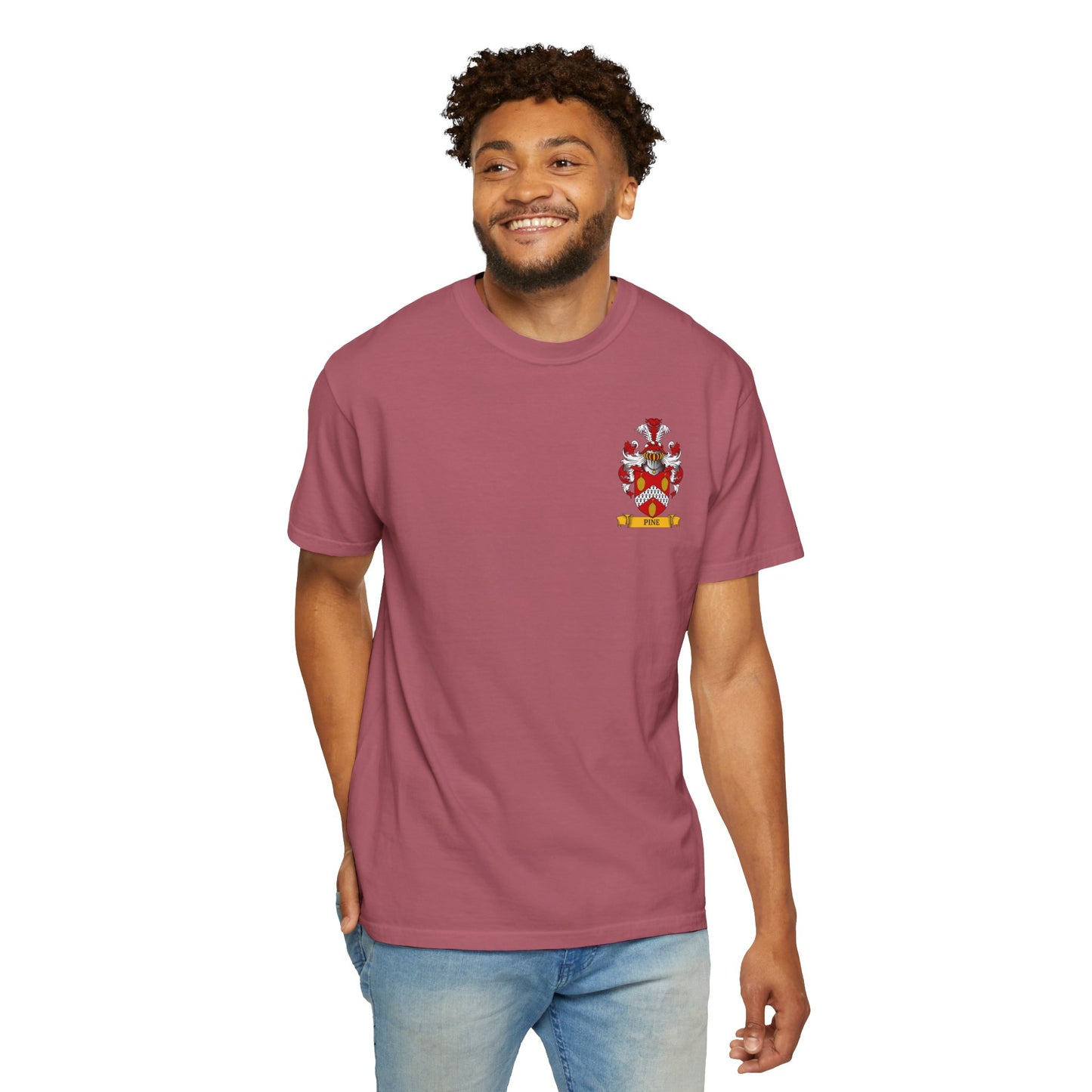 Young man wearing a Garment-Dyed  maroon t-shirt printed with his coat of arms on a white background