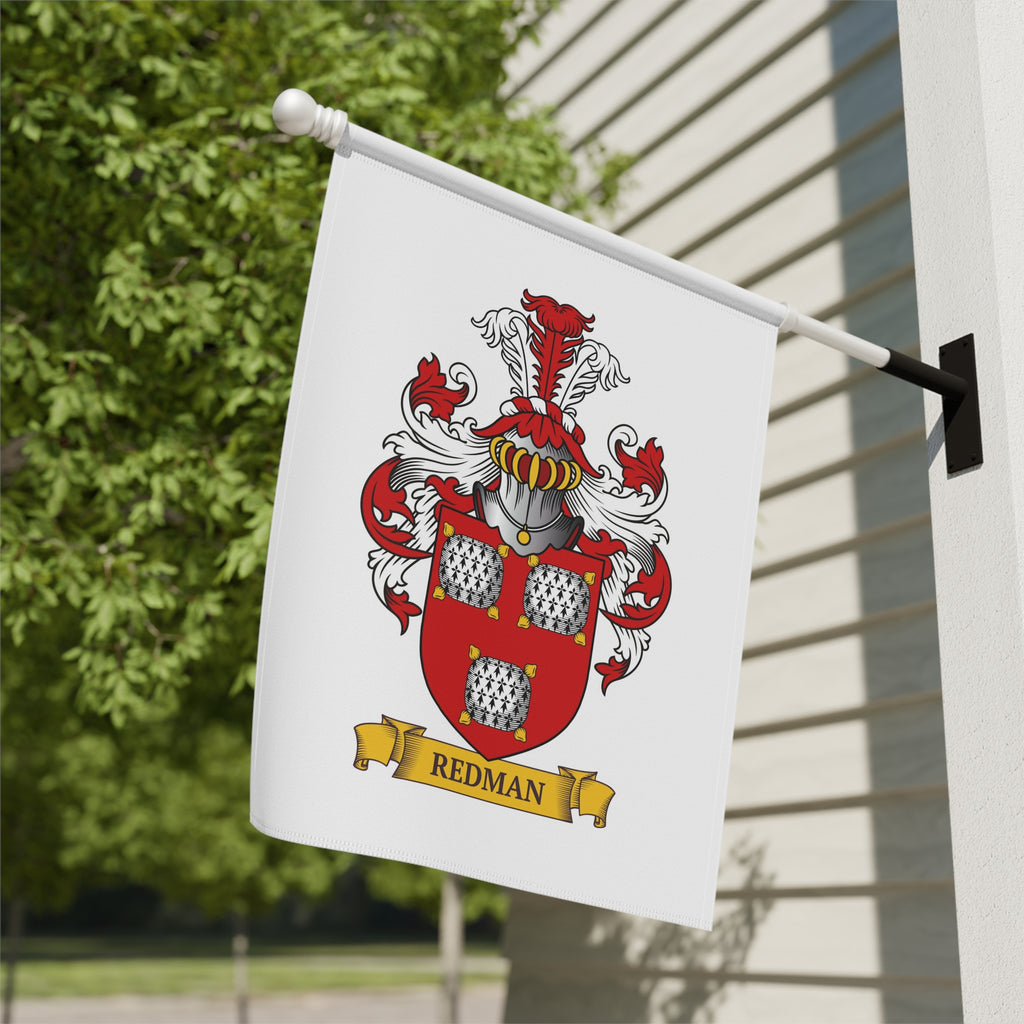 Personalized white family crest garden flag hanging on a building exterior.