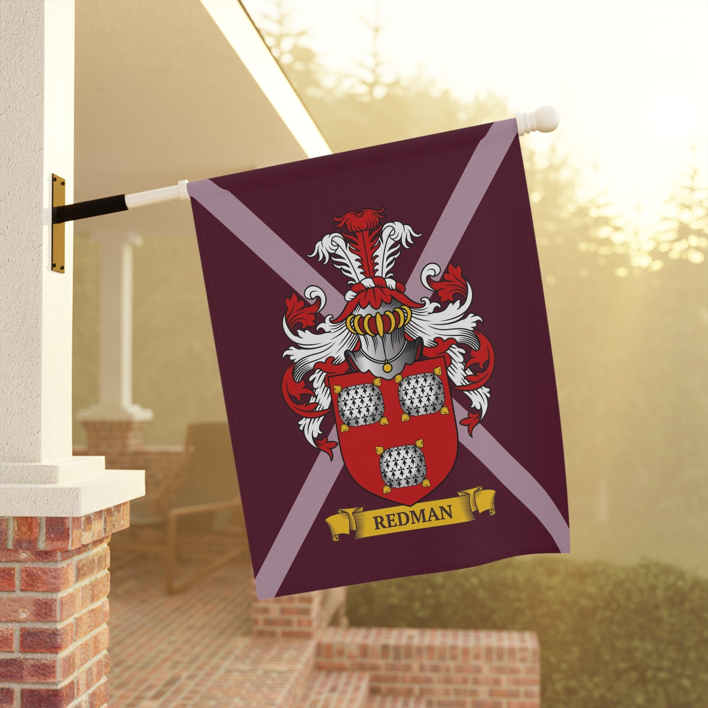Garden Flag with a coat of arms and customized last name hanging on a flagpole outdoors.