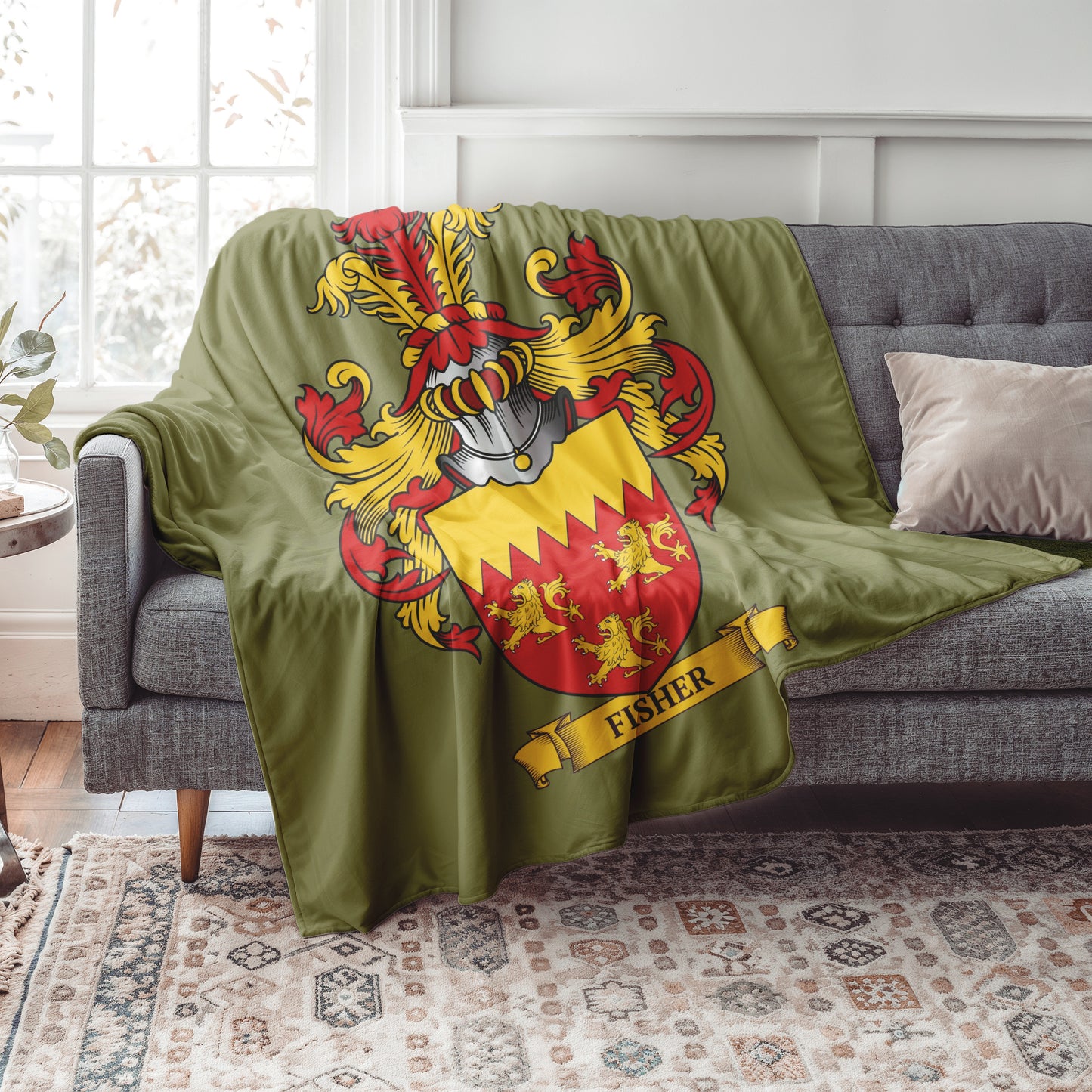Personalized Green blanket with a colorful coat of arms design draped over a gray sofa in a living room.