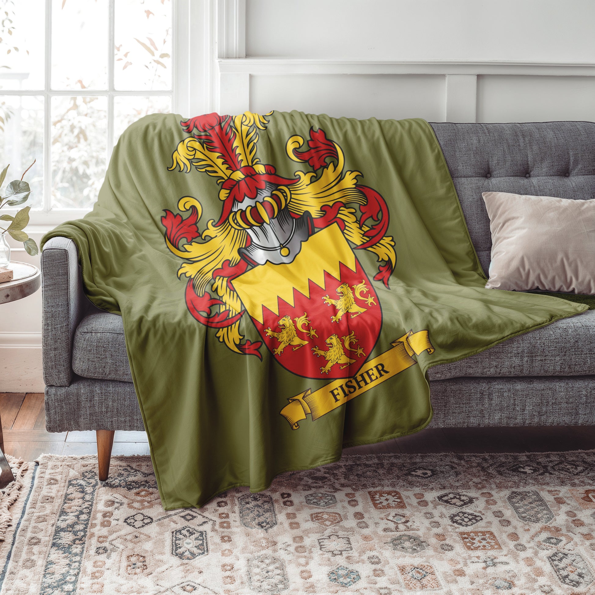 Personalized Green blanket with a colorful coat of arms design draped over a gray sofa in a living room.