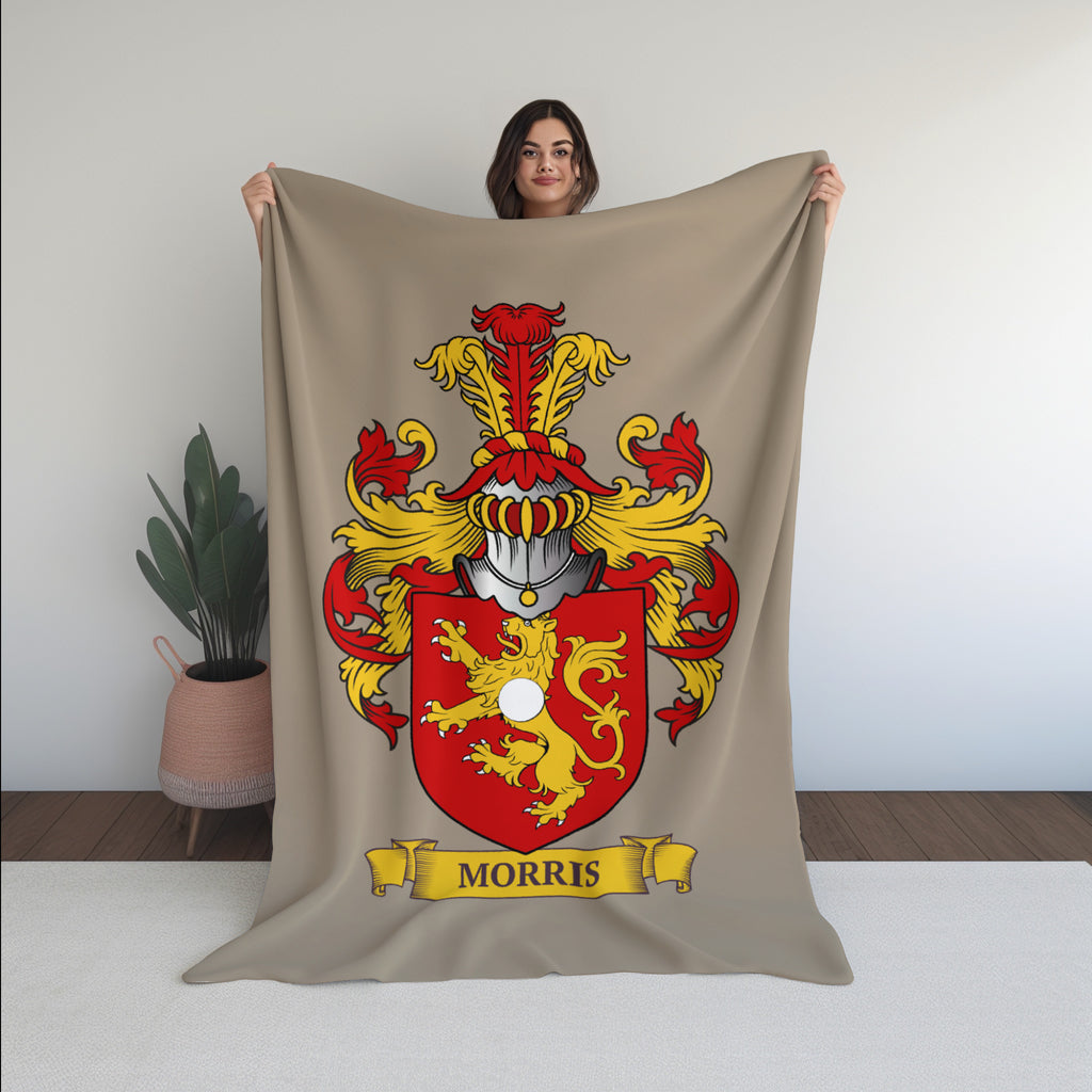 Woman holding a Personalized beige blanket with a coat of arms design featuring the last name 'Morris'.
