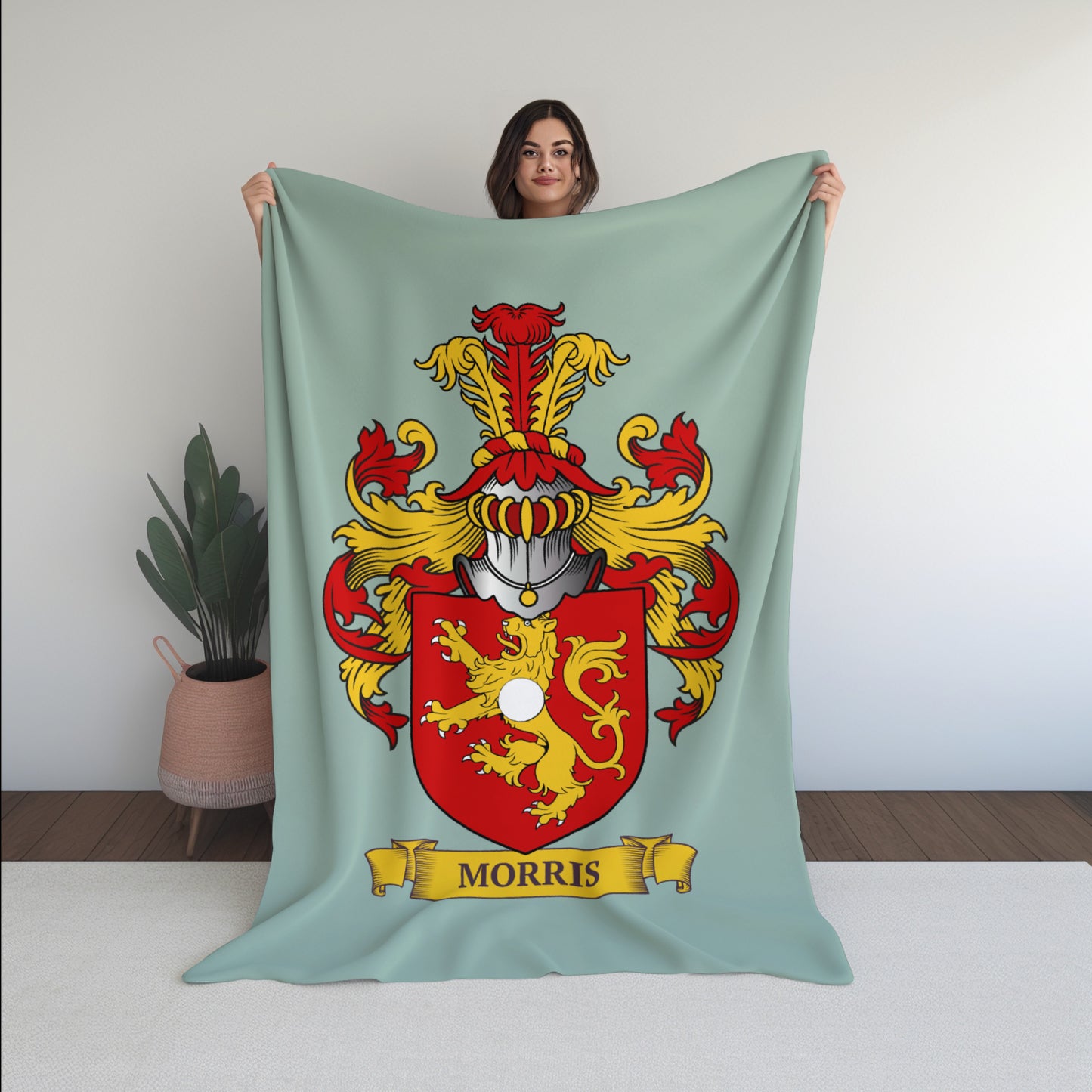 Young woman holding a Personalized blanket with a Morris family crest design against a white background