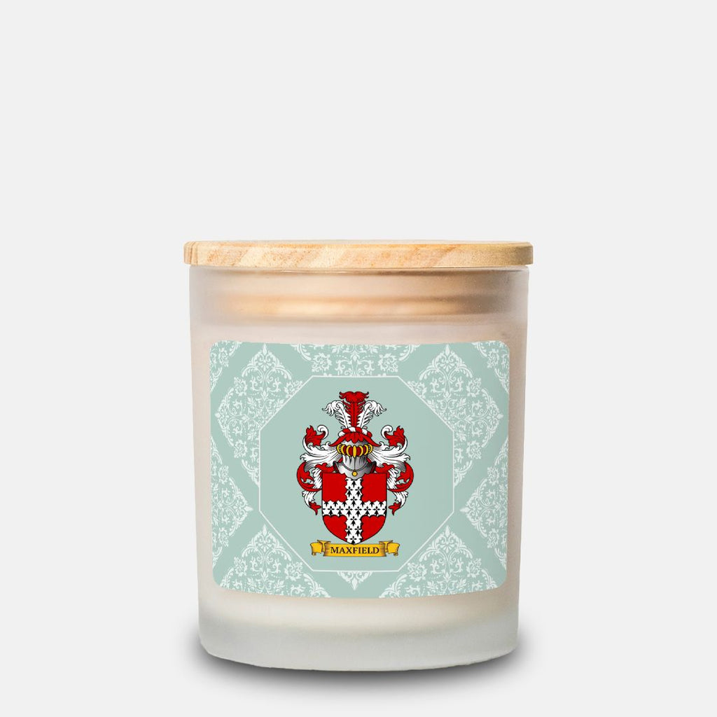 Personalized green candle with a decorative label featuring a crest and text on a pastel green background