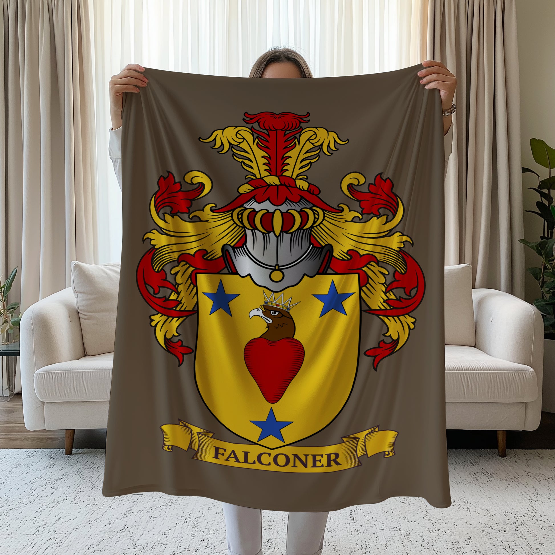 Person holding a Personalized velveteen brown blanket with a colorful coat of arms design, in a living room.