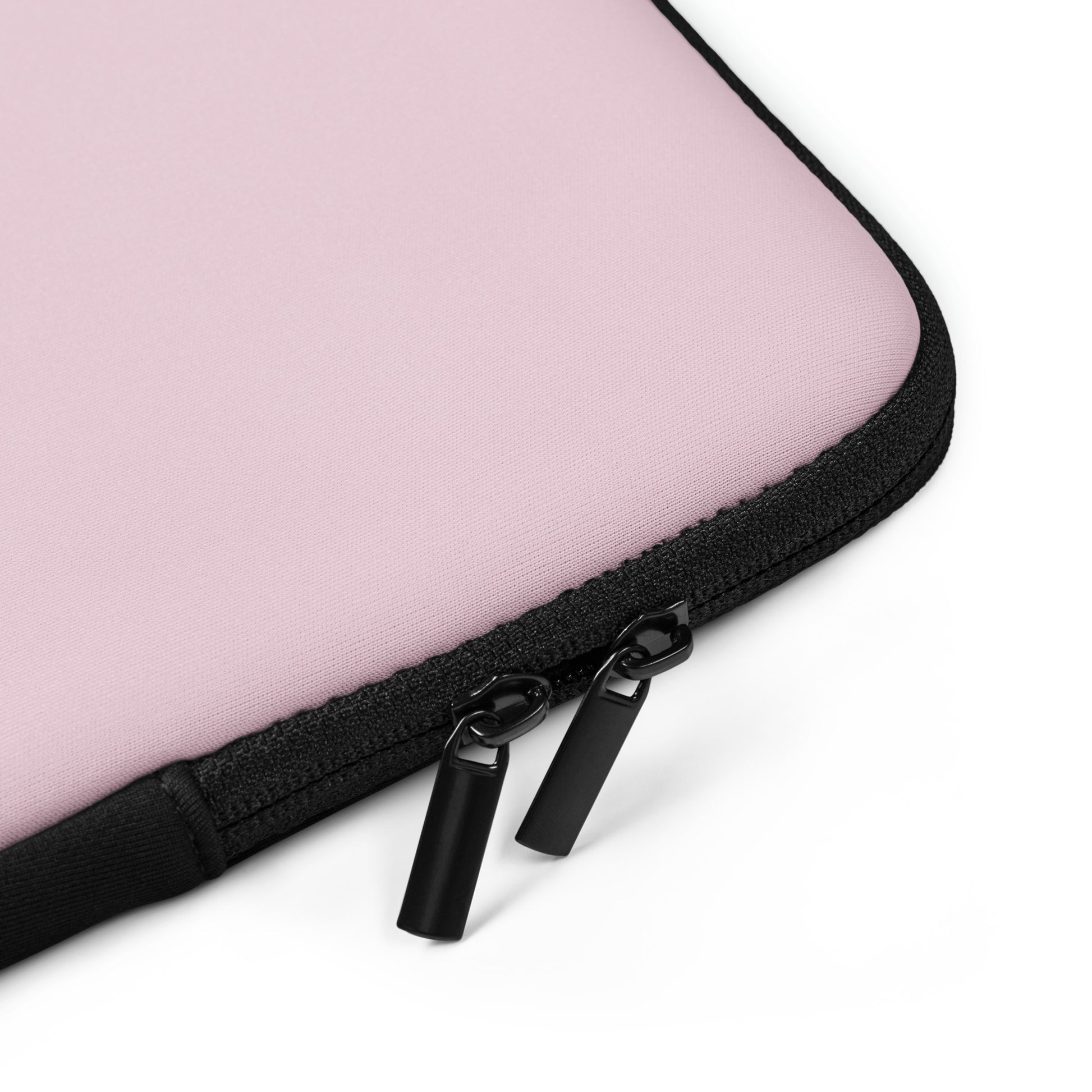Close-up of a pink laptop case with a black zipper on a white background